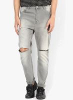 Incult Tapered Jeans In Light Grey With Knee Rips